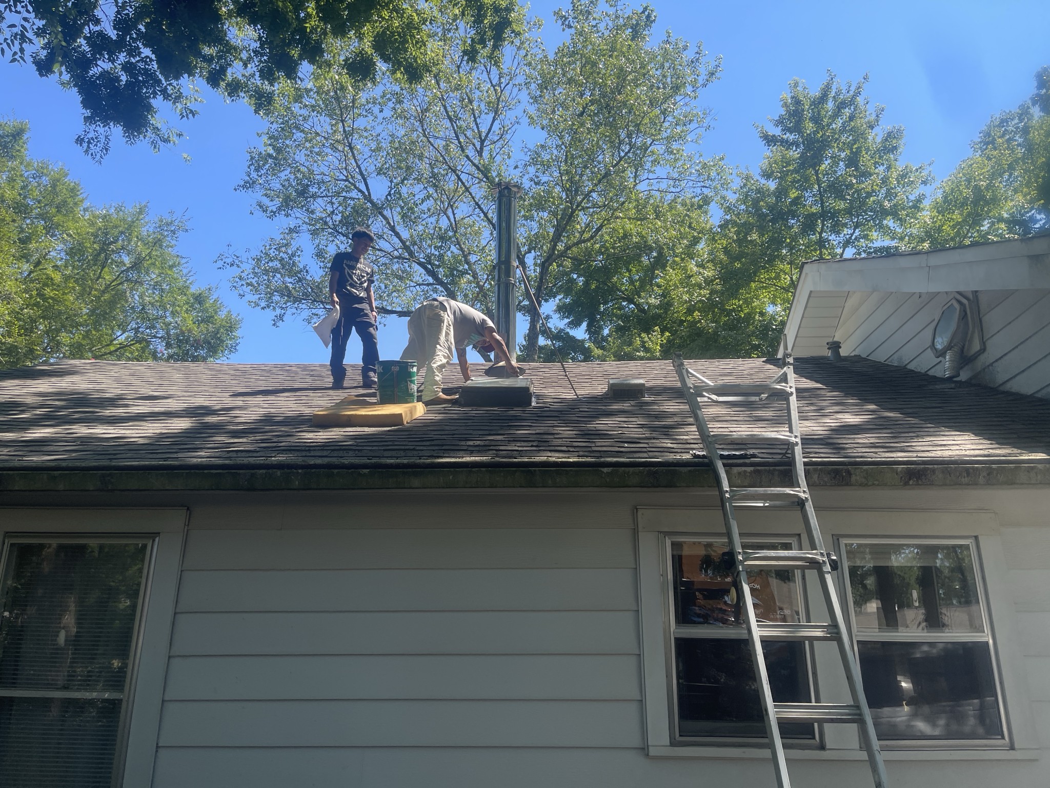 Hero Roofing crew members working on the roof of a home in Central Arkansas