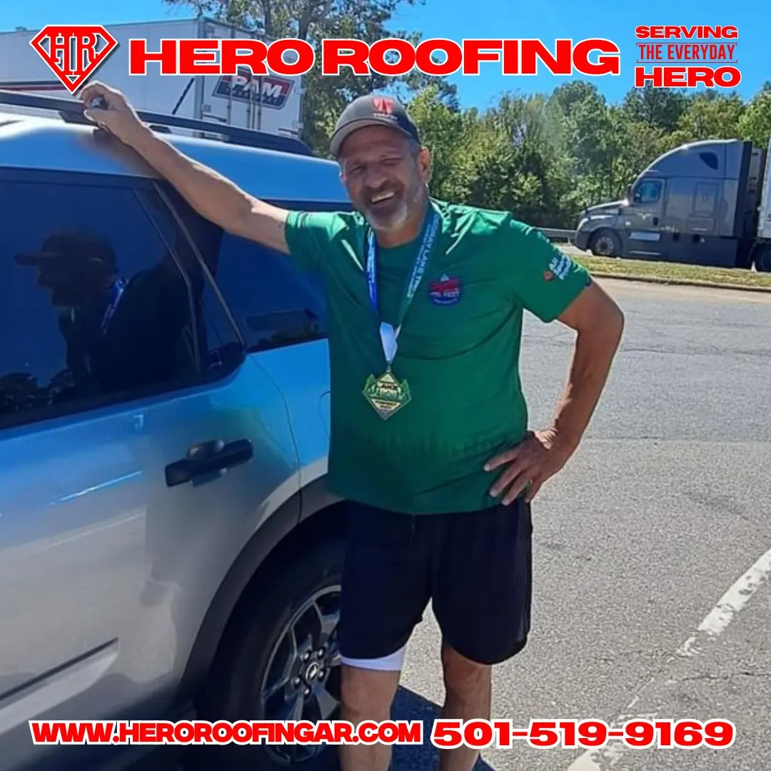 Hero Roofing team member with a finisher's medal at a local race in Central Arkansas