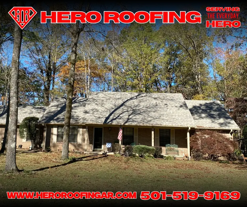 Light asphalt shingle roof on a house surrounded by trees