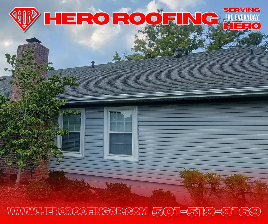 Dark asphalt shingle roof above gray siding
